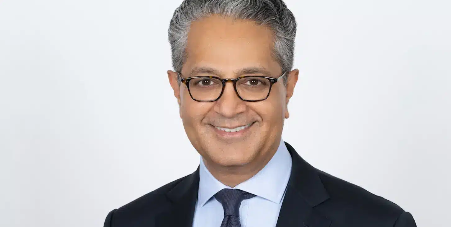 Professional portrait of Salim Ramji, CEO of Vanguard, in a suit against a white background.